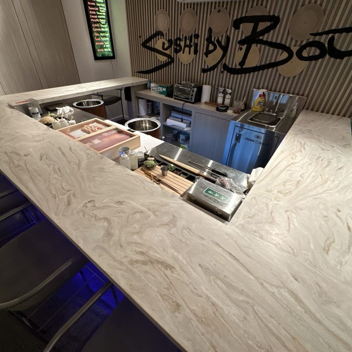 Interior of Sushi by Bou, completed in 2023, showcasing custom millwork including elegant wooden paneling and intricate details, located in Hoboken, NJ.