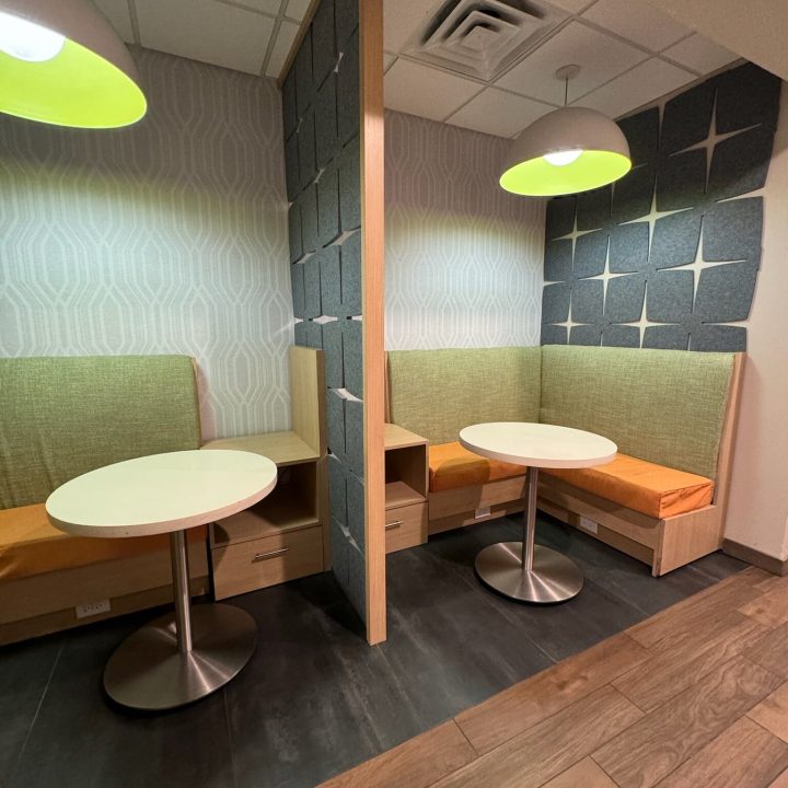 Interior of Hampton Inn, completed in 2023, showcasing contemporary design with cozy seating areas, elegant furnishings, and modern decor accents, located in Newark, NJ.