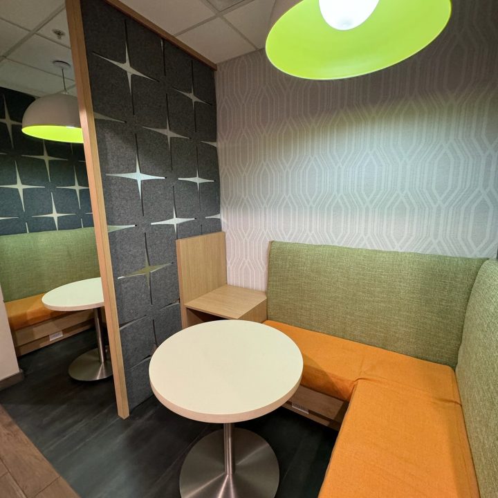 Interior of Hampton Inn, completed in 2023, showcasing contemporary design with cozy seating areas, elegant furnishings, and modern decor accents, located in Newark, NJ.