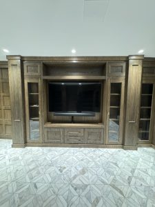 Interior of Llyod Harbor Residence, completed in 2024, featuring custom millwork in the bar area, state-of-the-art cinema room, and stylish game room, located in Long Island, NY