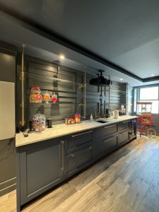 Interior of Llyod Harbor Residence, completed in 2024, featuring custom millwork in the bar area, state-of-the-art cinema room, and stylish game room, located in Long Island, NY