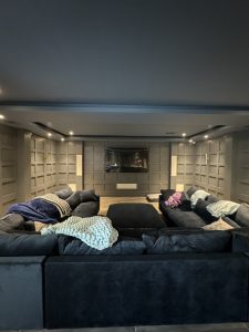 Interior of Llyod Harbor Residence, completed in 2024, featuring custom millwork in the bar area, state-of-the-art cinema room, and stylish game room, located in Long Island, NY