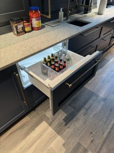 Interior of Llyod Harbor Residence, completed in 2024, featuring custom millwork in the bar area, state-of-the-art cinema room, and stylish game room, located in Long Island, NY