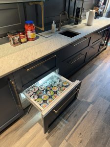 Interior of Llyod Harbor Residence, completed in 2024, featuring custom millwork in the bar area, state-of-the-art cinema room, and stylish game room, located in Long Island, NY