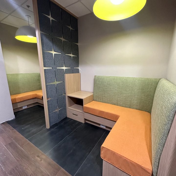 Interior of Hampton Inn, completed in 2023, showcasing contemporary design with cozy seating areas, elegant furnishings, and modern decor accents, located in Newark, NJ.