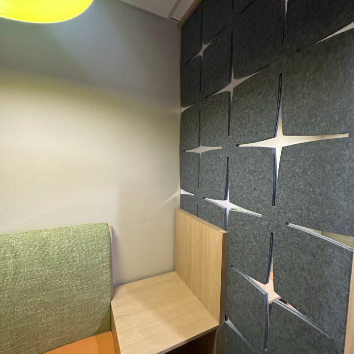 Interior of Hampton Inn, completed in 2023, showcasing contemporary design with cozy seating areas, elegant furnishings, and modern decor accents, located in Newark, NJ.