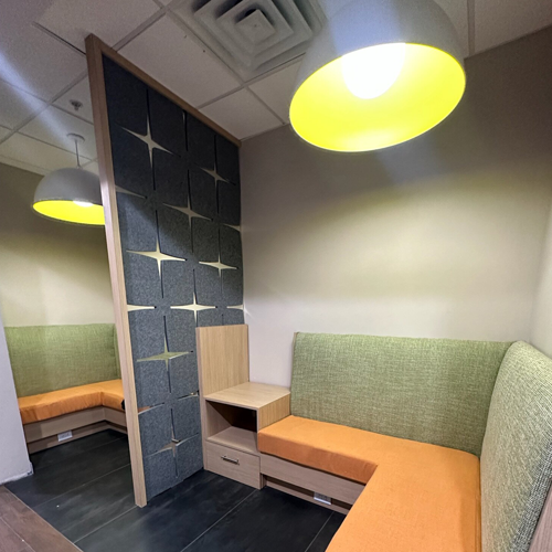 Interior of Hampton Inn, completed in 2023, showcasing contemporary design with cozy seating areas, elegant furnishings, and modern decor accents, located in Newark, NJ.